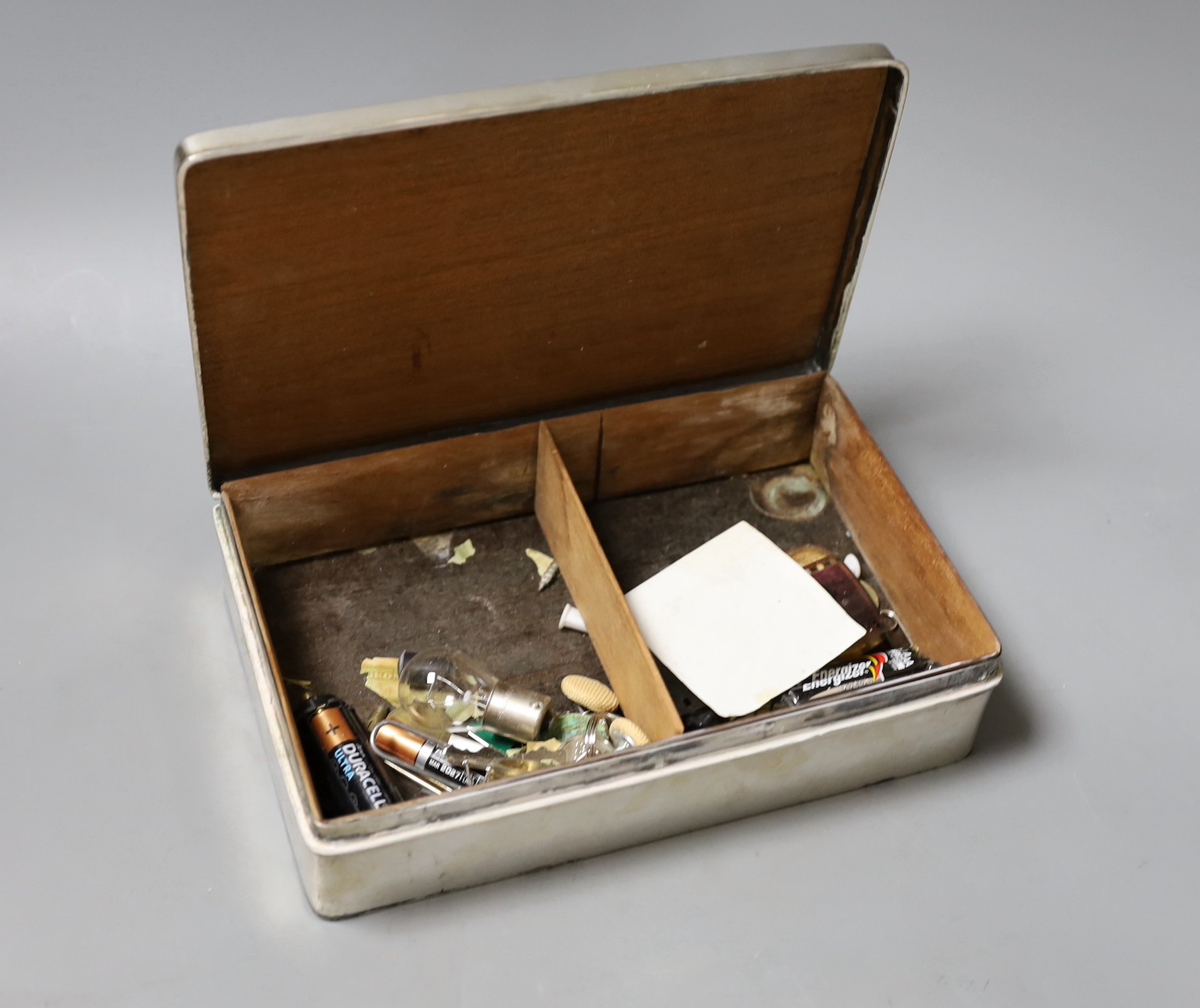 A Chinese Export white metal mounted cigarette box, by Wang Hing, Hong Kong, the lid decorated with a dragon, 21cm.